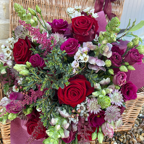 Red and purple bouquet by florist